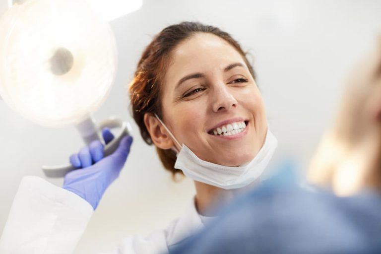 happy-dentist-looking-at-patient-EH54GLD (1)